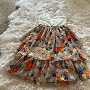 Strapless dress with tiered floral ruffles.